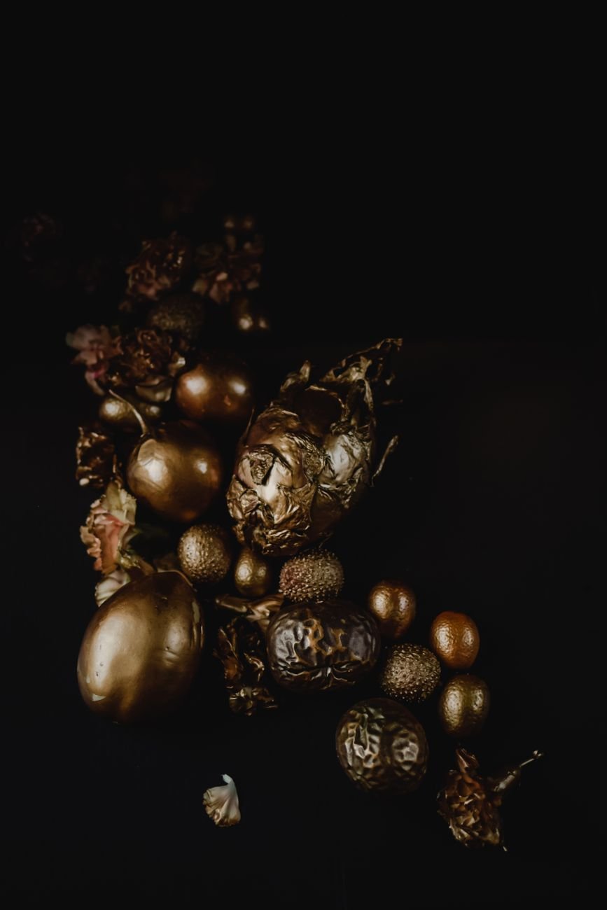 Luxurious golden ornaments on dark background — premium home decor items